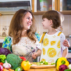 XLSXEXCL lemon kids apron in-use cooking highlighting mess-friendly design