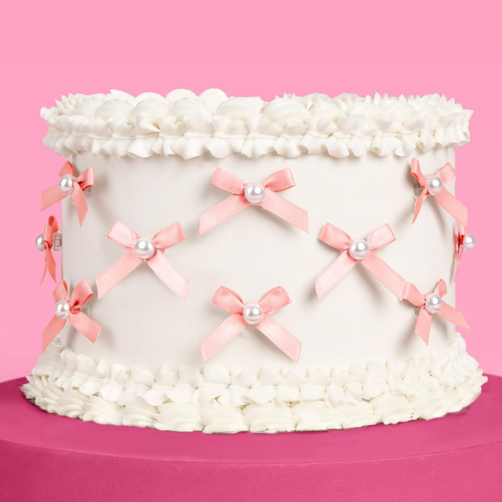 xo Fetti mini pink bow pearl cake topper adds elegant charm to birthday cake