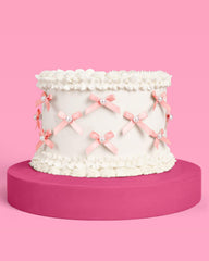 xo Fetti mini pink bows with pearls decorating a cake with style