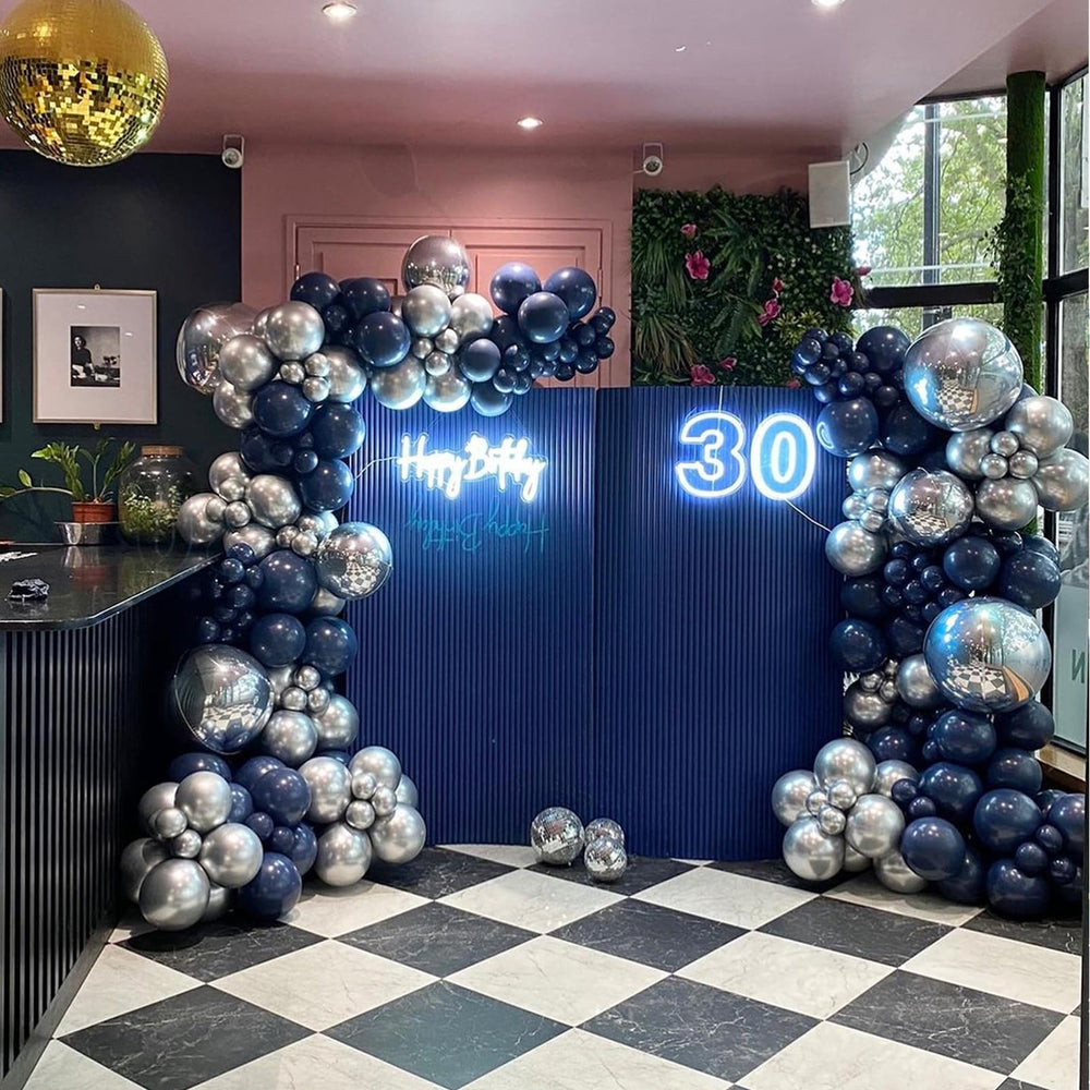 YMSZ navy blue and silver balloons forming an elegant backdrop.