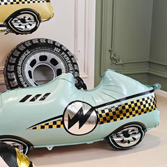 YOIOZAIZAI blue race car balloon as a photo backdrop.
