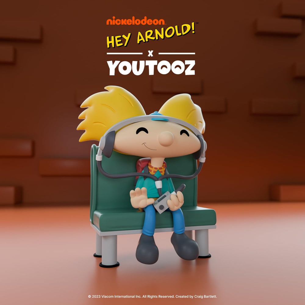 Youtooz Arnold vinyl figure holding cassette player for fun desk decor.