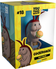 Youtooz cockroach figure on a barrel serves as a quirky desk display.