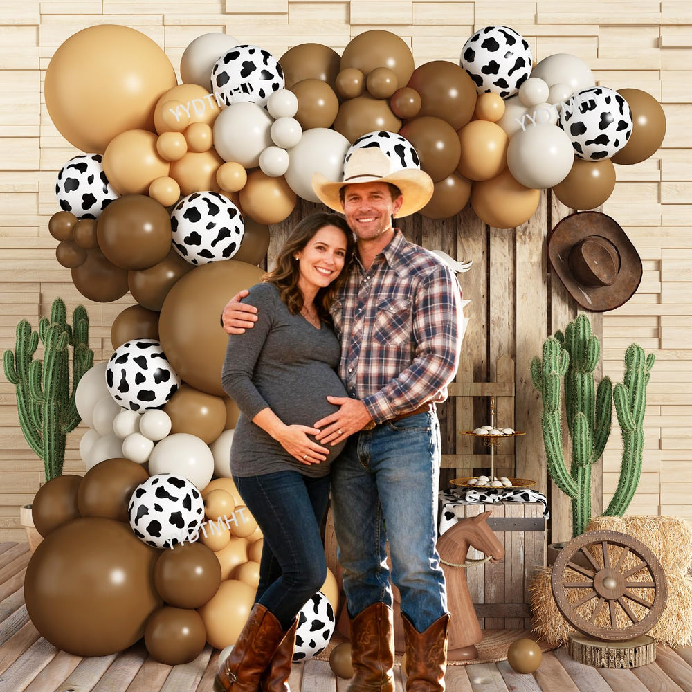 YYDTMHT cow print balloons add rustic charm to the arch.