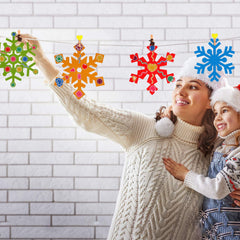 DIY hanging snowflake ornaments crafted with Zonon kit on a window