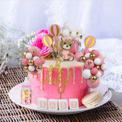 Acmee pink ladder topper provides whimsical height and style.