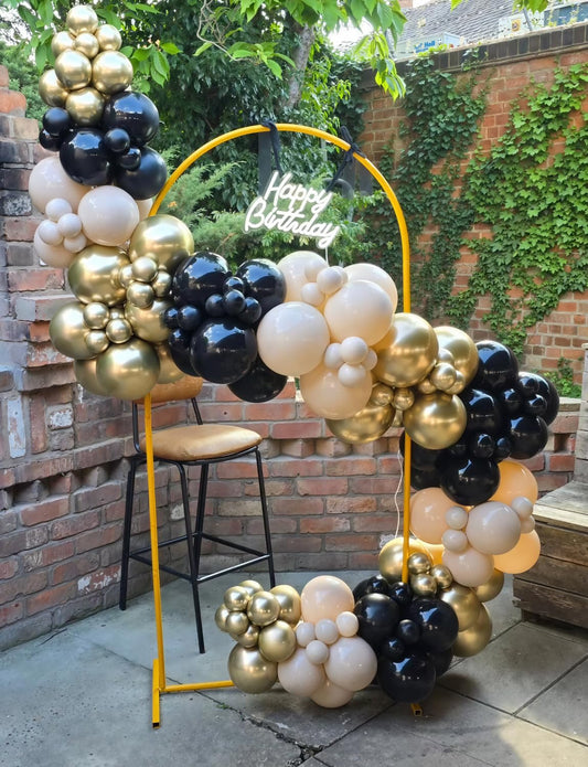 Giant star foil balloons cream and black add dramatic focal points.