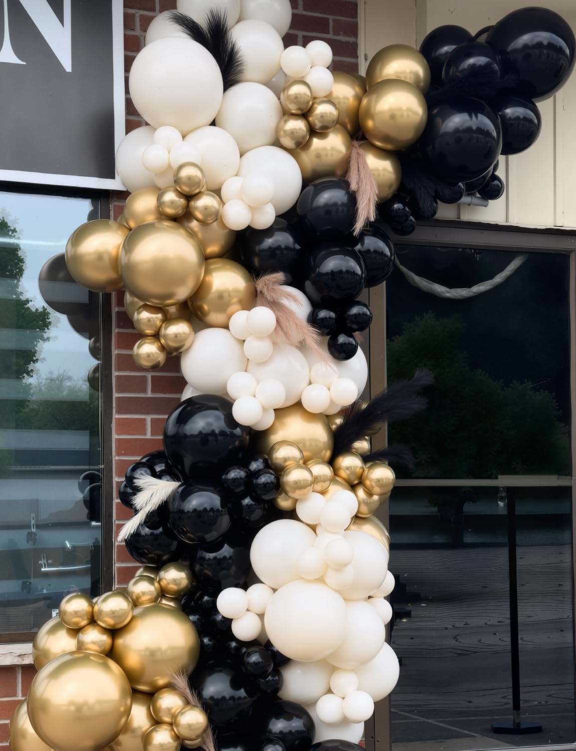 Glue dots and white ribbon help secure the balloon arch.