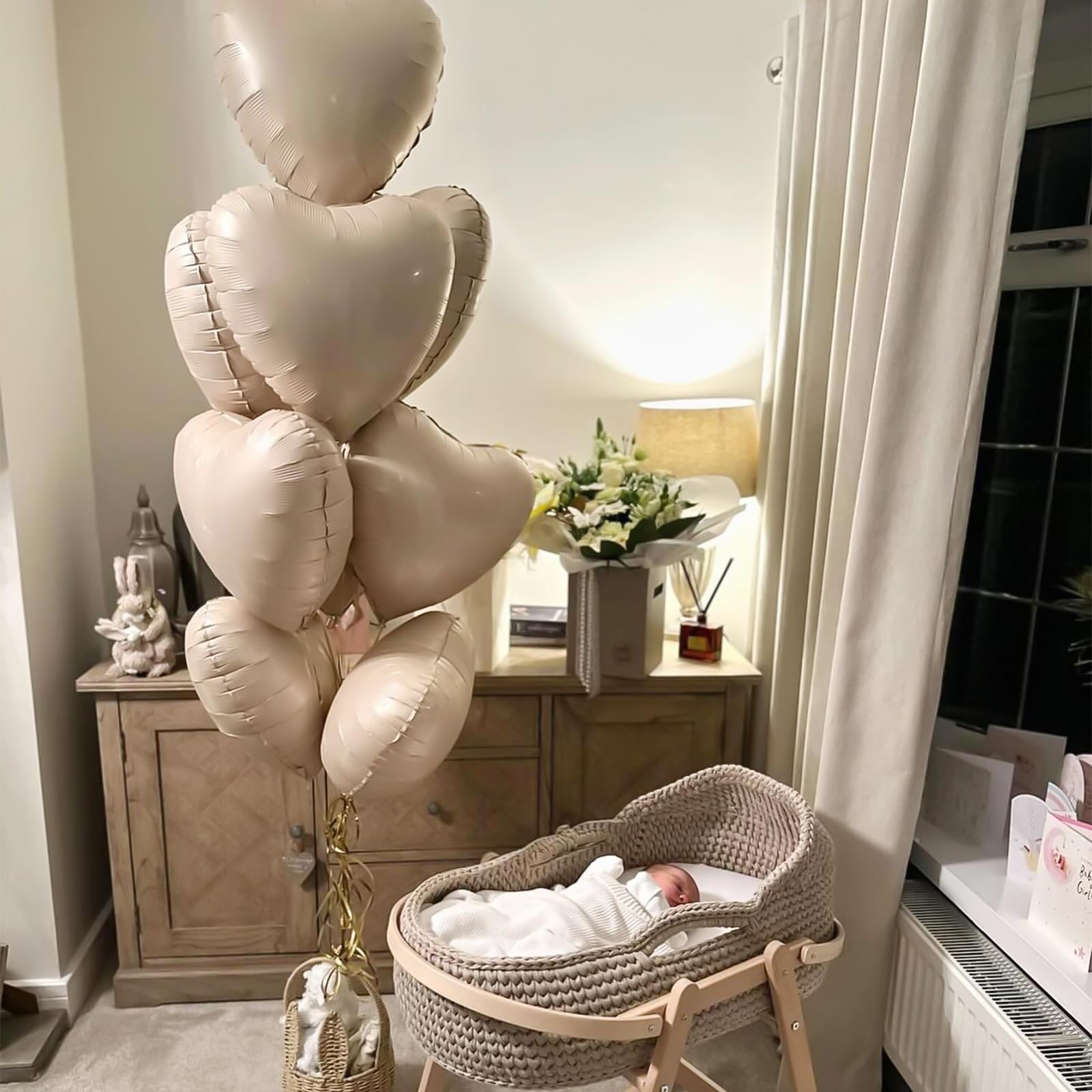 Adorely baby shower decor with cream heart balloons.