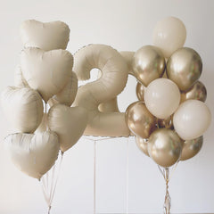 Adorely wedding or anniversary decor with cream heart balloons.