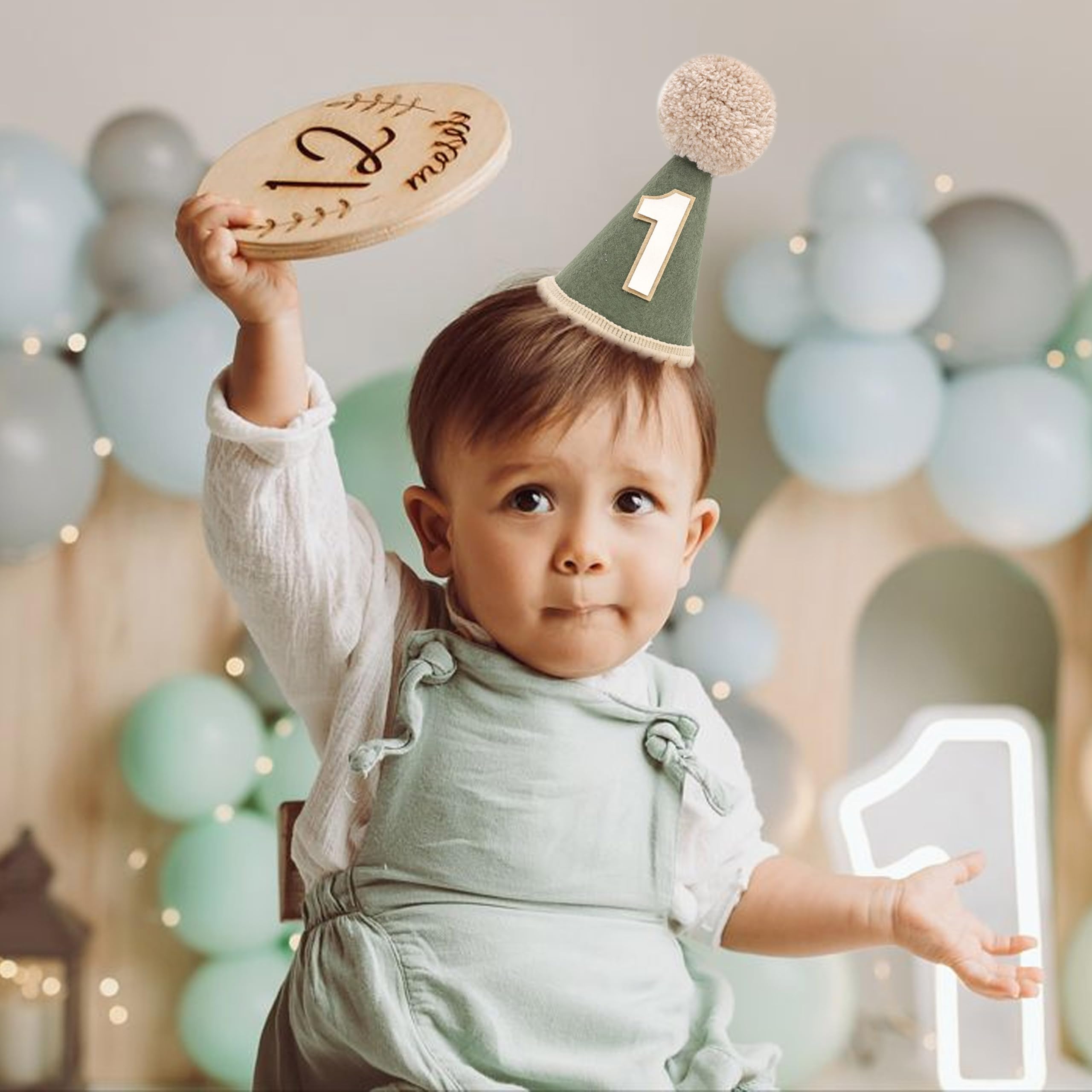 Agvgaza first birthday hat with green tones complements jungle-themed decor and photography.