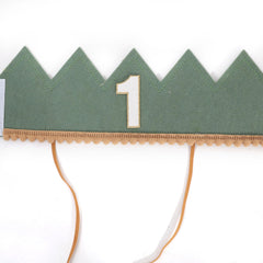 Number 1 accent on the crown emphasizes the milestone.