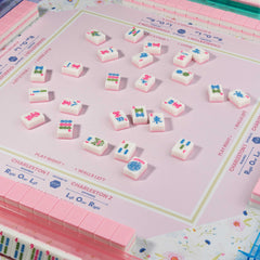 Printed American mahjong rules on the mat for quick reference during play.