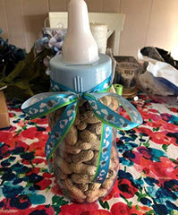 Amscan Blue Baby Bottle Bank displays hearts along the side for a charming keepsake.