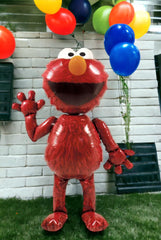 Decor idea: red Elmo AirWalker balloon as party centerpiece and backdrop.
