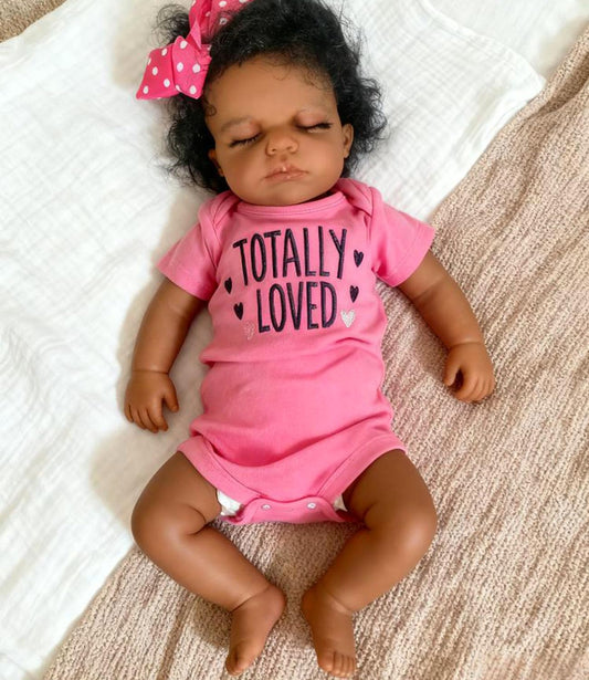 Anano 20-inch full body doll in brown skin, sleeping pose for realistic nurturing play