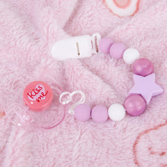 Aori pacifier clip set in purple pairs with dolls for coordination.