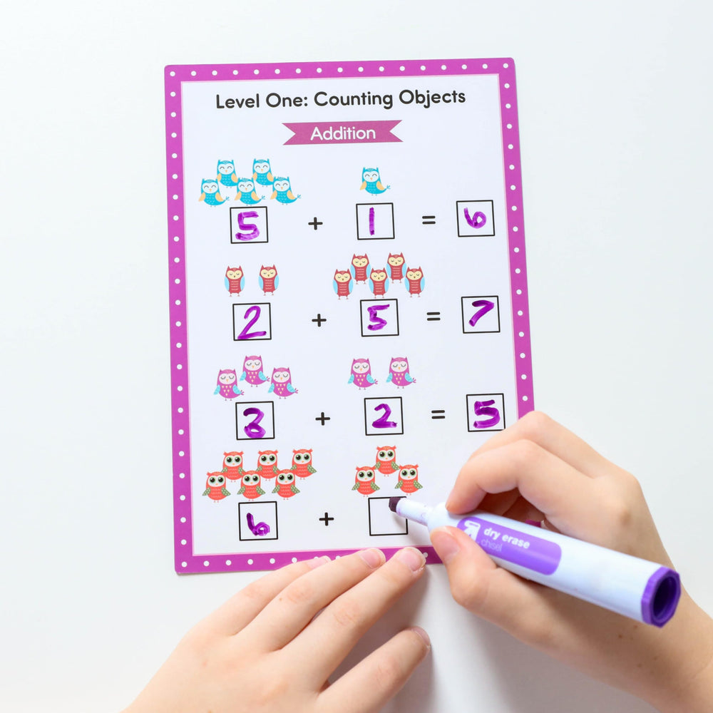 Apostrophe Games dry erase markers in use with cards – kid-friendly learning moment.