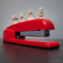 Tiny gargoyles sit on your desk, adding playful guardian vibes.