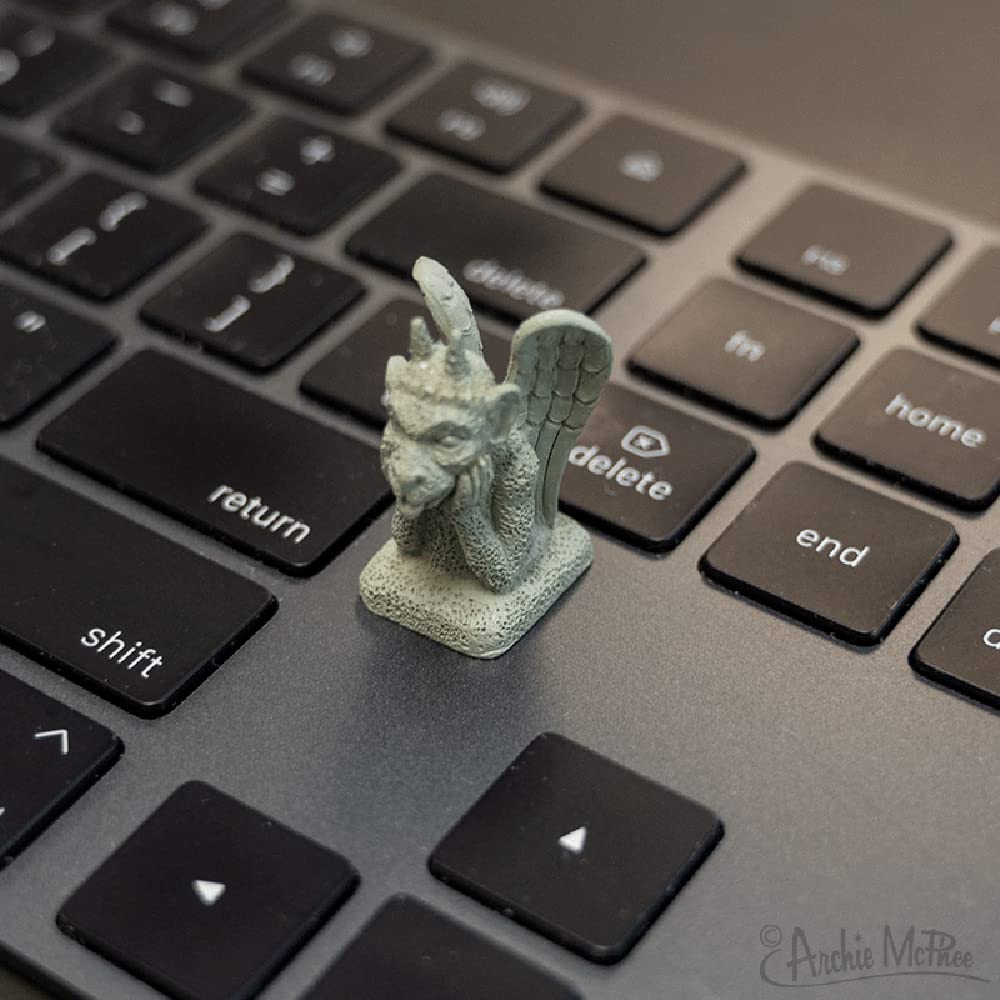 Set of four gargoyles creates a tiny cathedral feel on a workspace.