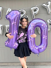 Argthjy large purple number balloon stands tall in party decor.