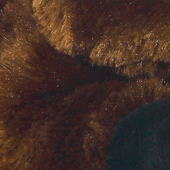 Aurora Mini Flopsie Brown Toro resting on belly; ideal for calm play.