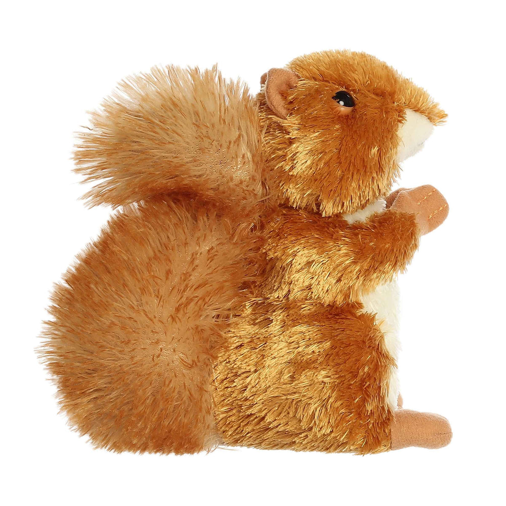 Aurora Nutsie mini plush resting on belly encourages easy snuggling.