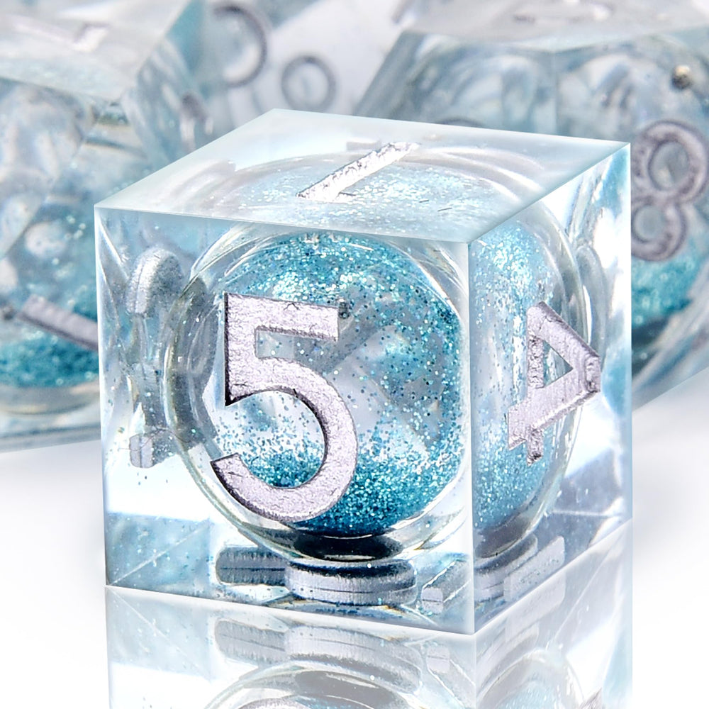 AUSTOR resin dice close-up showing mirrored finish and gemstone-like edges.