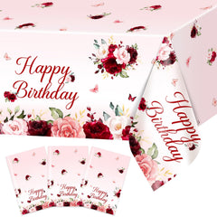 Avezano burgundy floral birthday tablecloth 108x54 on table for spill protection.