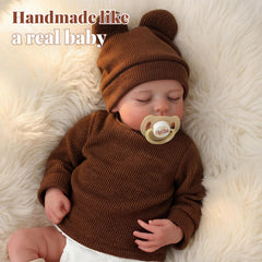 BABESIDE Reborn Baby Doll Boy wearing bear hat enhances imaginative nurturing.