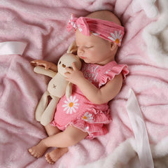 Babeside silicone baby doll weighted for a floppy newborn feel during cuddles.