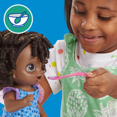 Baby Alive doll fed with the included spoon for interactive meals.
