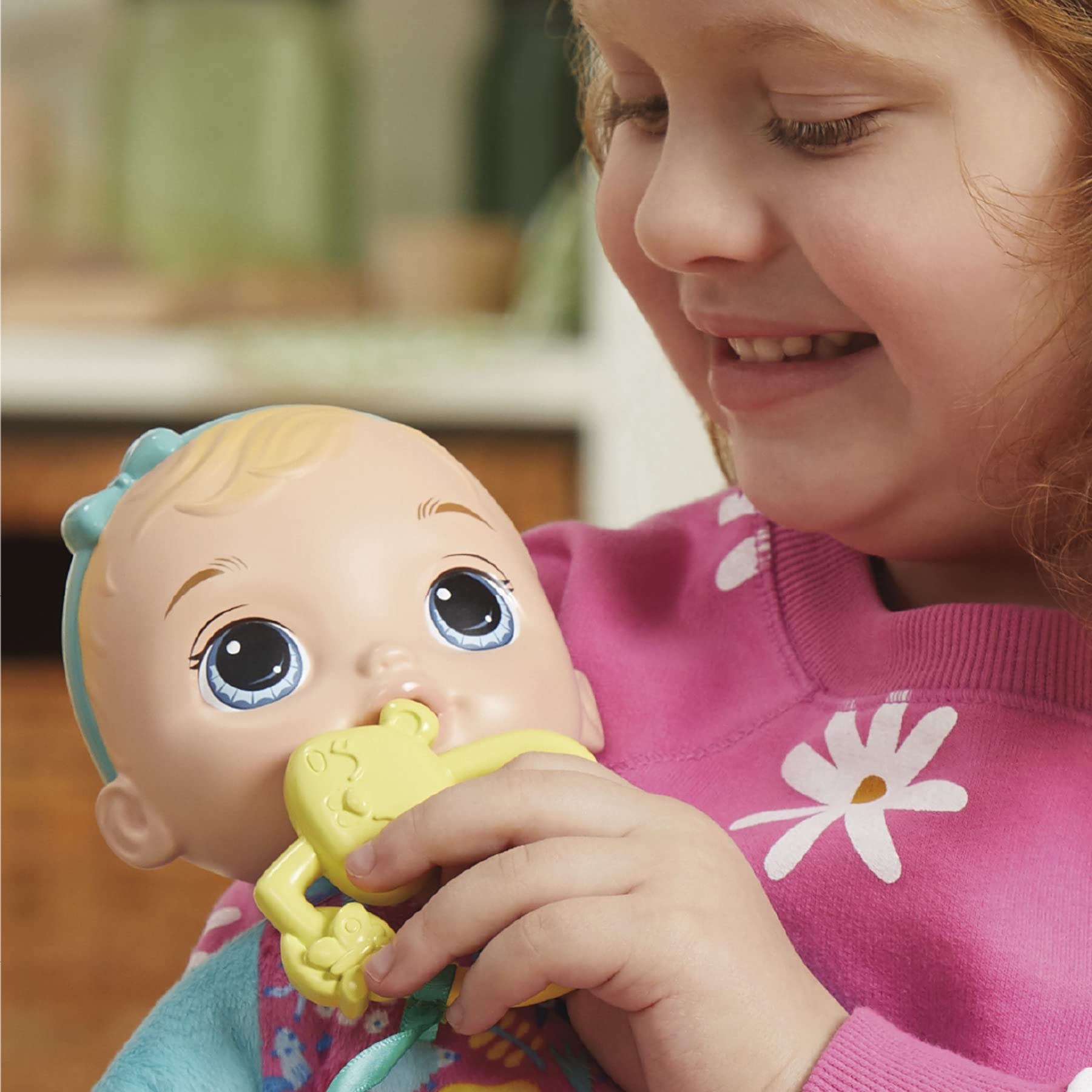 Attached aqua headband and bow on Baby Alive doll for durable dress-up