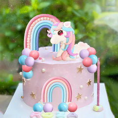 White unicorn figurine topper creates a dreamy focal point for celebrations
