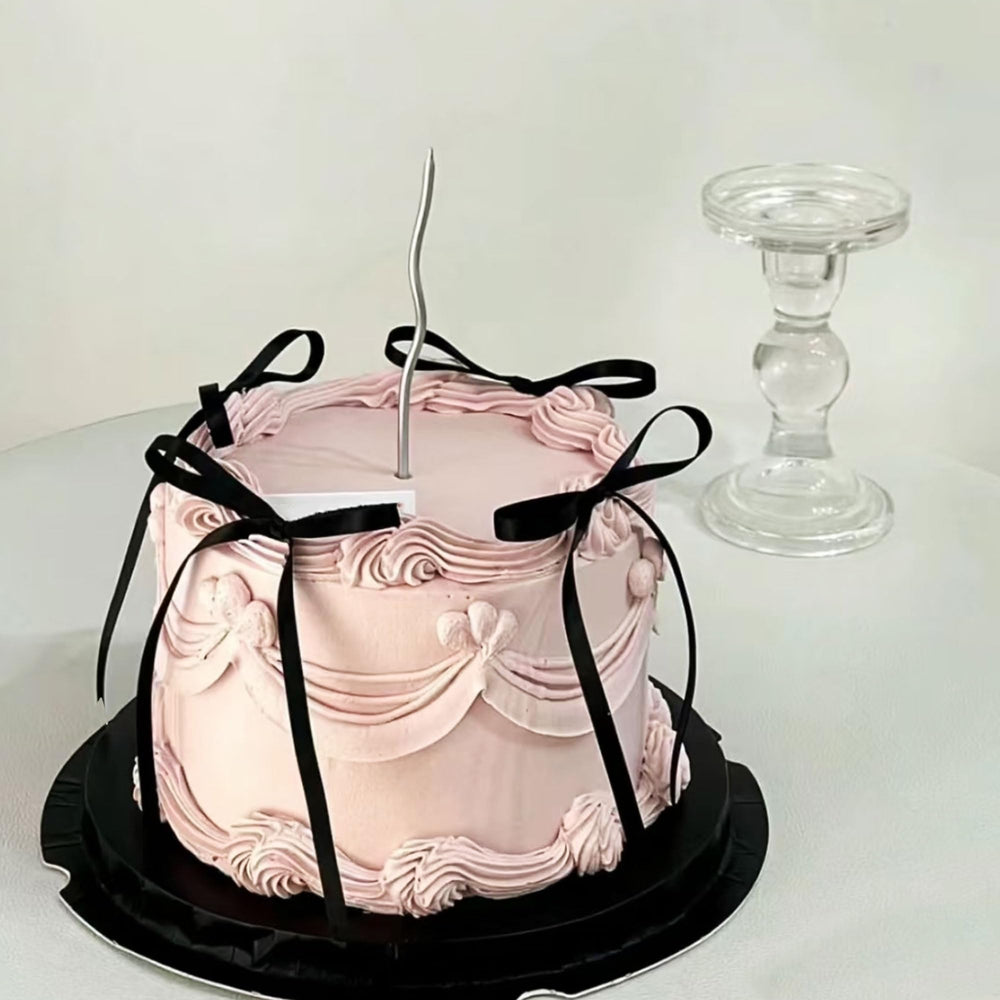 Bach and Boujee coquette bow toppers create a refined cake decoration theme.