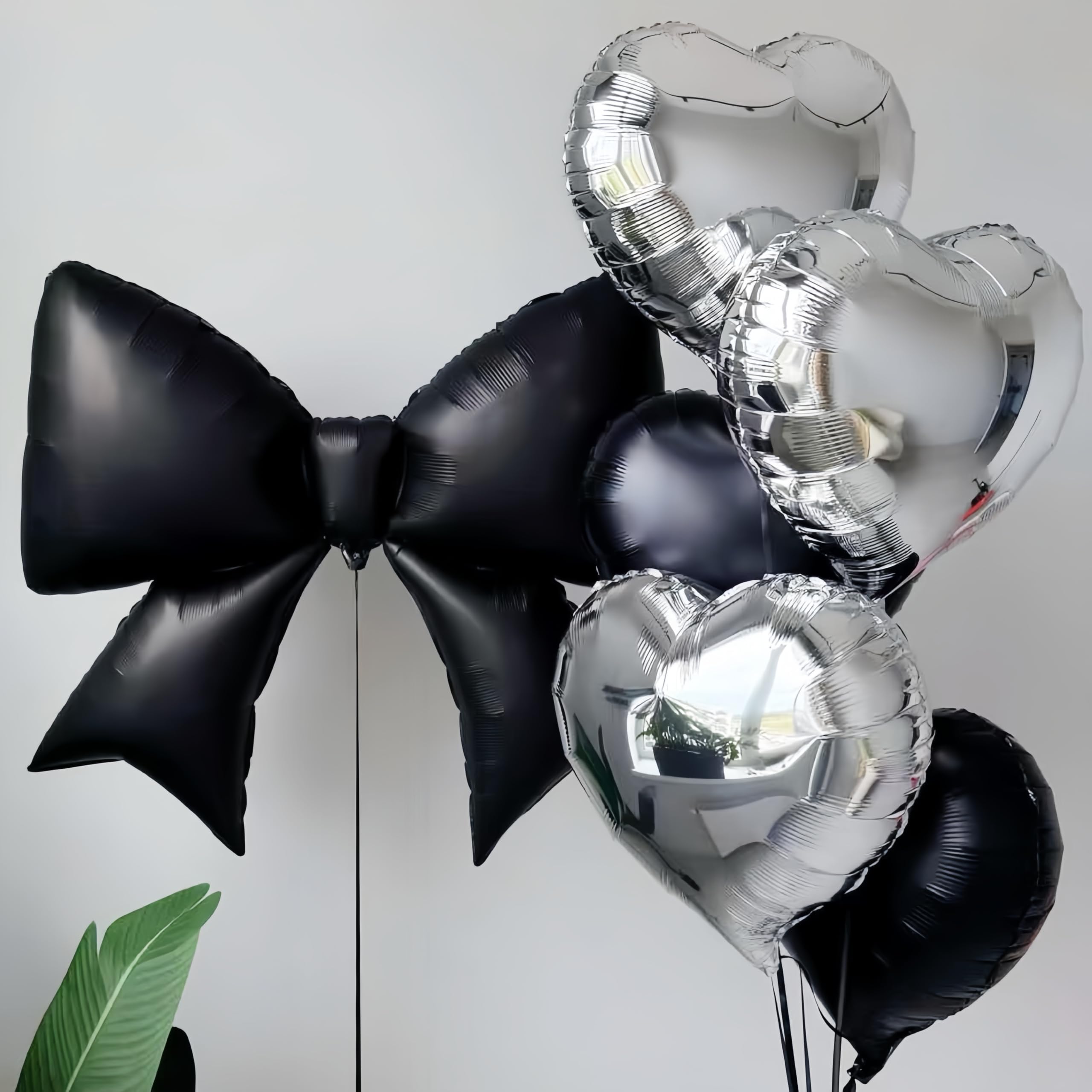 Baoonworlld black bow balloon paired with gold accents for gothic or palace-themed celebrations.