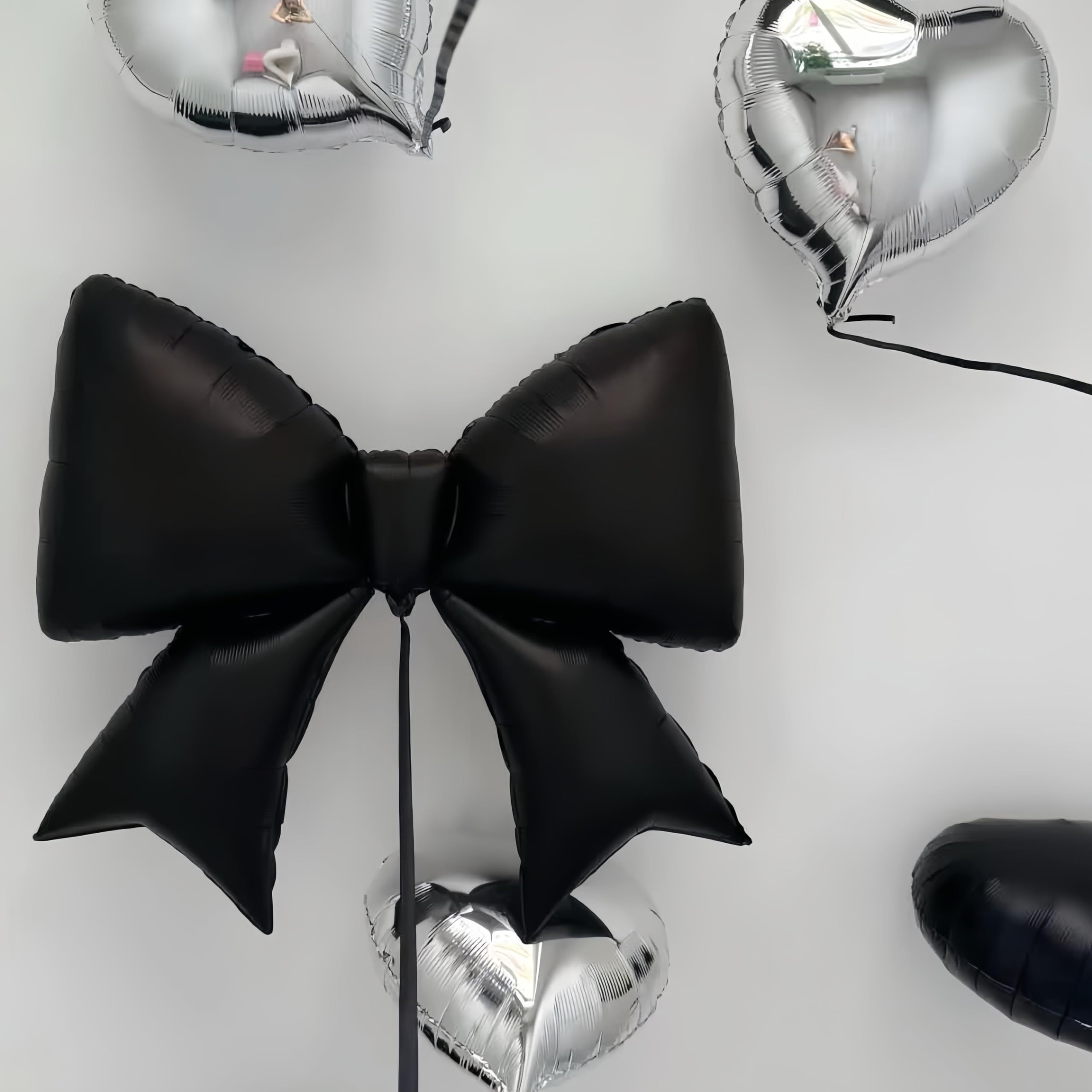 Baoonworlld 38-inch black bow balloon creates a striking focal point for weddings and parties.