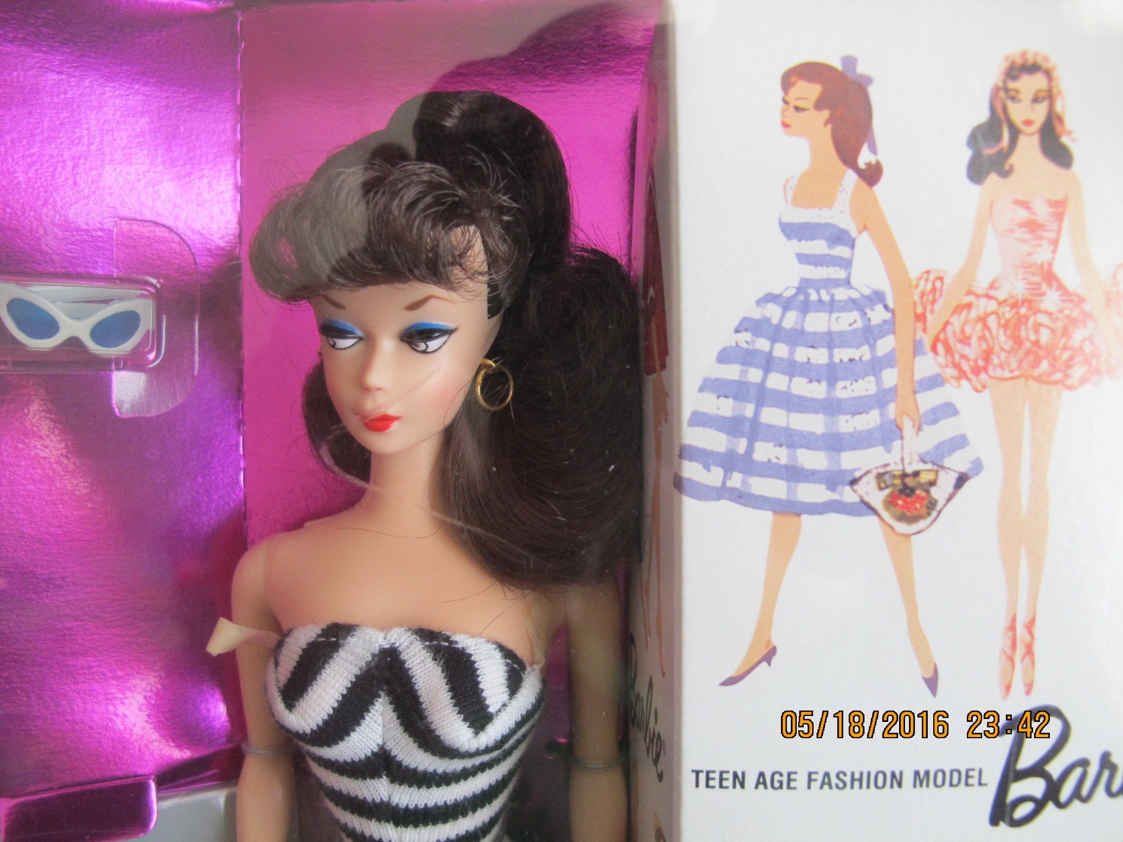 Barbie 1959 reproduction doll in box with sunglasses and high heel shoes.
