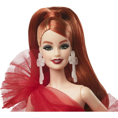 Barbie 2024 Holiday doll with red hair and shimmering accents, keepsake-worthy.