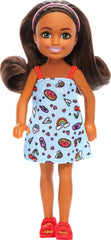 Barbie Chelsea doll in blue dress with colorful print for imaginative play.