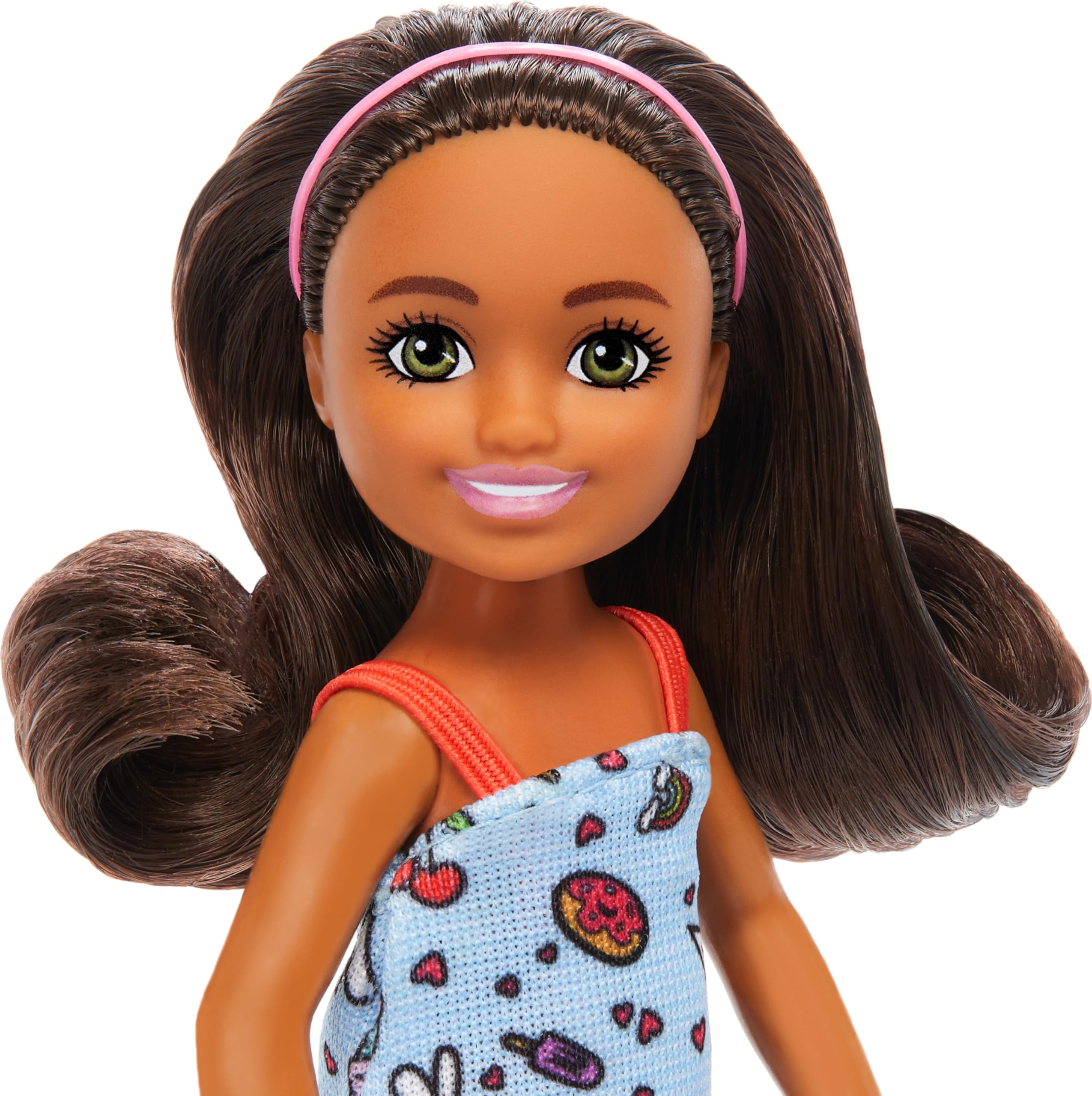 Barbie Chelsea doll with brown hair and headband, stylish and cute.