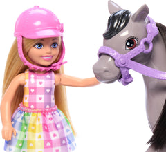 Barbie Chelsea doll seated on pink saddle with reins for pretend horseback riding