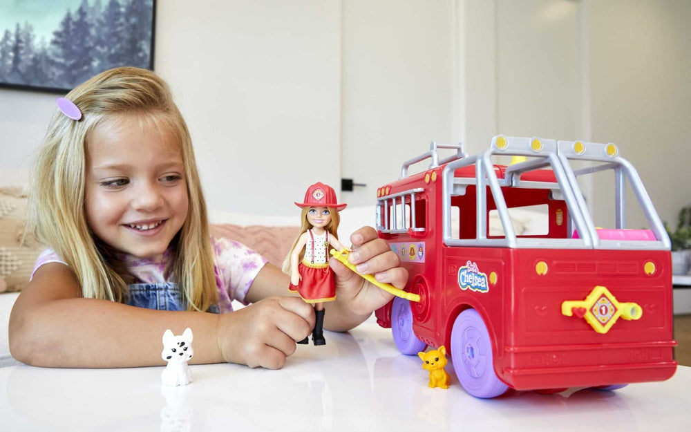 Barbie Chelsea uses the rescue ladder on the fire truck for adventurous play