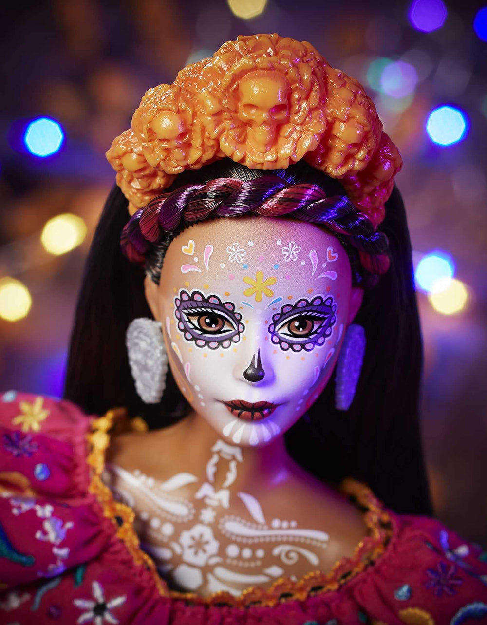 Barbie Dia De Muertos doll shows calavera face paint extending to the neck.