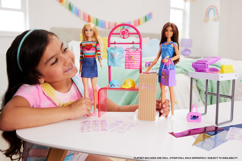 Barbie display rack and hangers showcasing created fashions in a pretend store