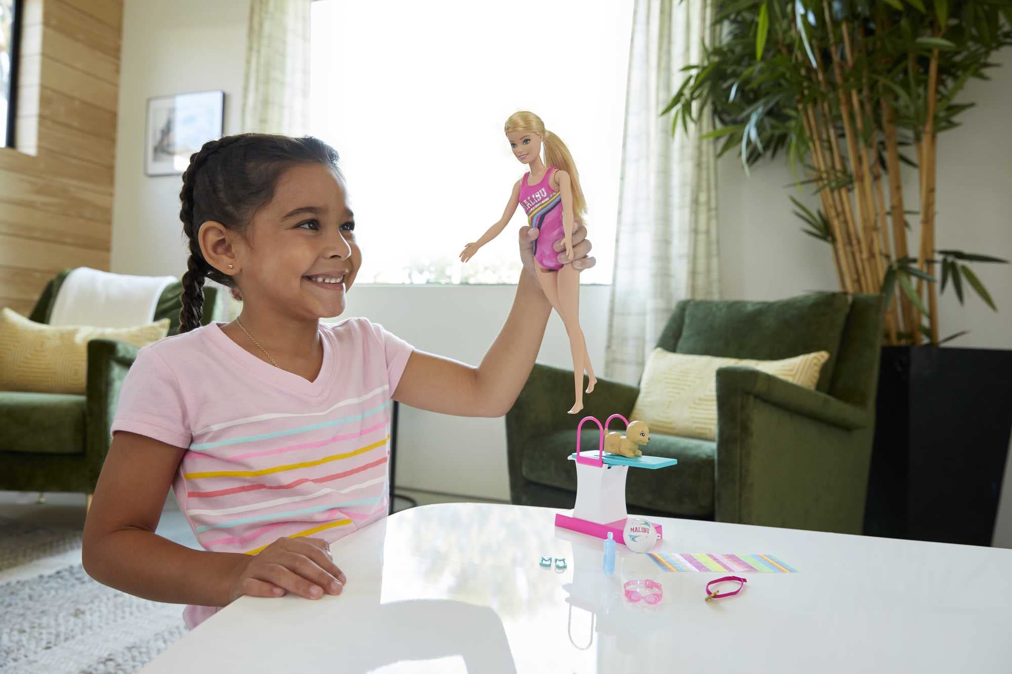 Barbie Dreamhouse Adventures Swim 'n Dive doll with waist lever activates swimming motion.