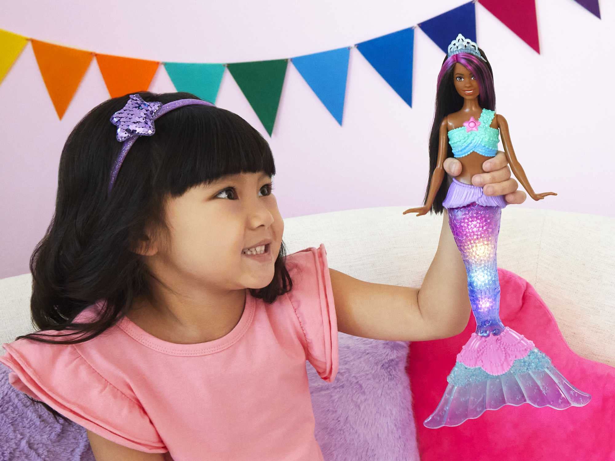 Barbie Dreamtopia tail glows in water for four shimmering light shows during water play.