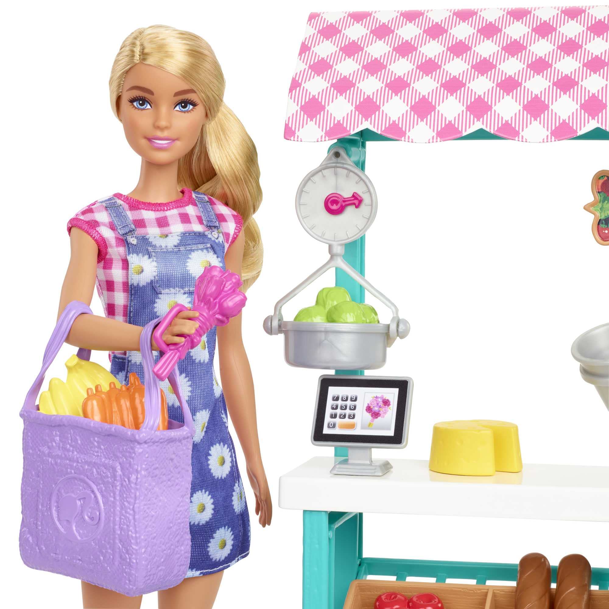 Barbie doll in gingham dress beside fruit and vegetable baskets for hands-on trading