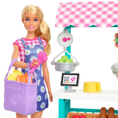 Barbie doll in gingham dress beside fruit and vegetable baskets for hands-on trading
