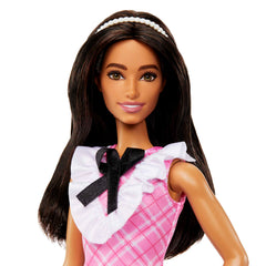 Barbie Fashionistas Doll 209 strappy heels complete a chic look.
